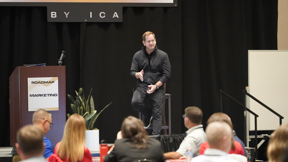 Josh Taylor speaking on stage